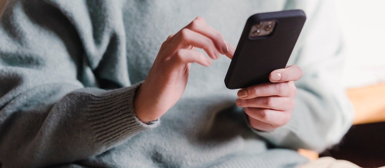 Woman surfing internet with mobile phone | Breast Cancer Car Donations