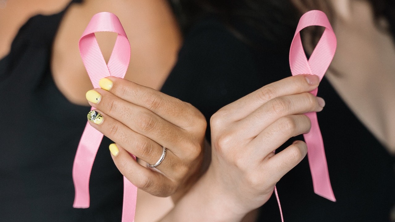 2 Women Holding Pink Ribbons | Breast Cancer Car Donations