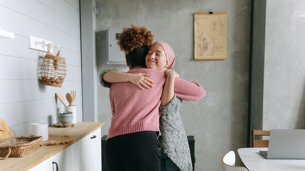 A Woman Hugging her Friend | Breast Cancer Car Donations