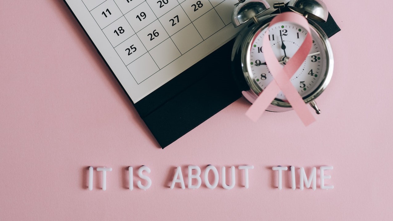 Close-Up Shot of a Pink Ribbon beside a Calendar  | Breast Cancer Car Donations