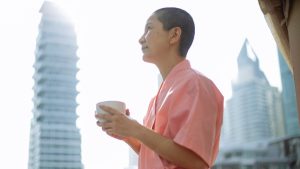 Short haired happy Asian woman with breast cancer enjoying tea | Breast Cancer Car Donations