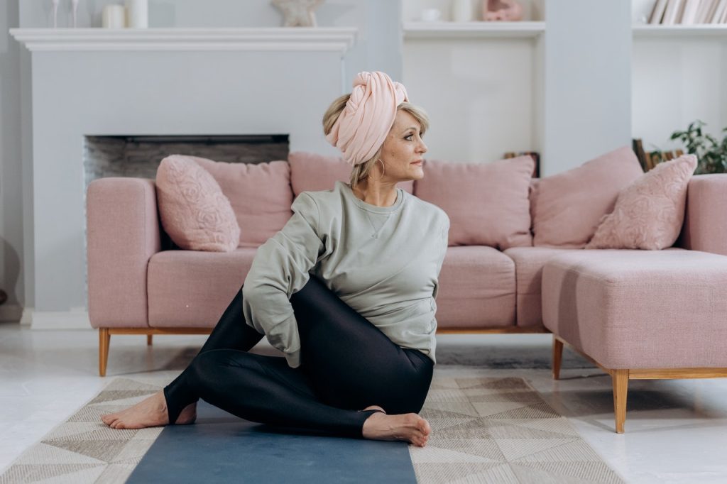 Woman Stretches at Home | Breast Cancer Car Donations