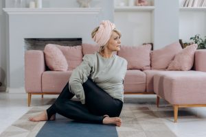 Woman Stretches at Home | Breast Cancer Car Donations