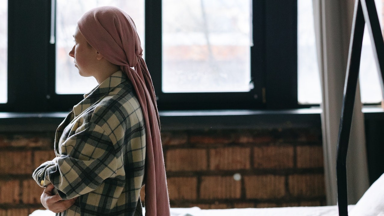 Woman Wearing a Pink Headwrap | Breast Cancer Car Donations