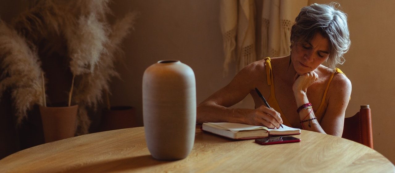 Woman Writing on Her Journal | Breast Cancer Car Donations