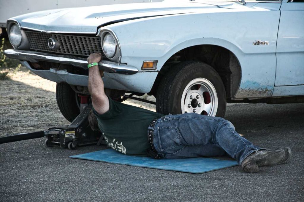 Mechanic Fixing Car | Breast Cancer Car Donations