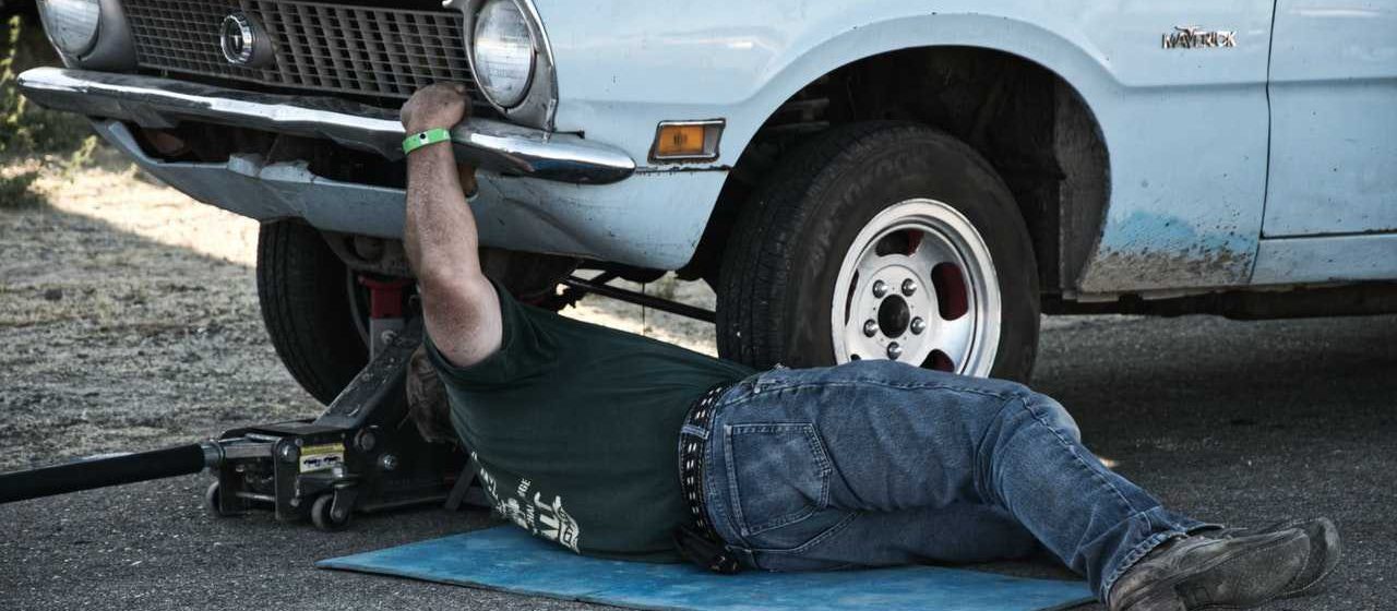 Mechanic Fixing Car | Breast Cancer Car Donations