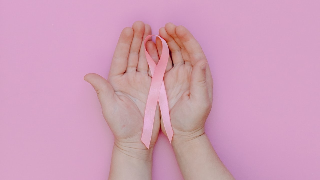 Person Holding Pink Ribbon | Breast Cancer Car Donations