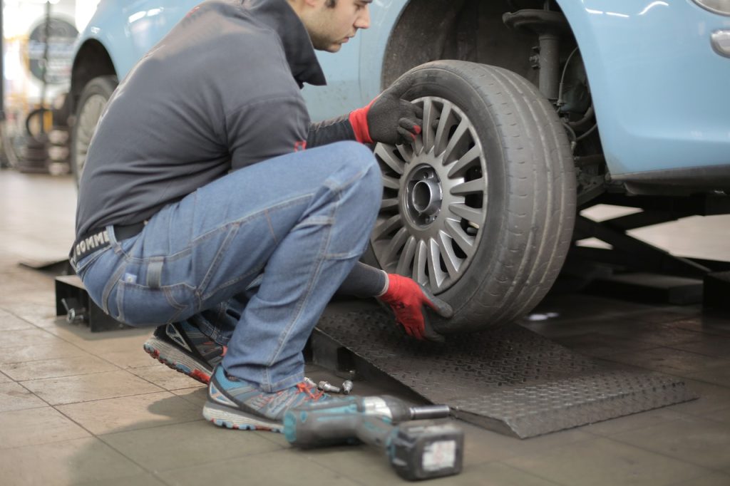 Servicing Old Car Tire | Breast Cancer Car Donations