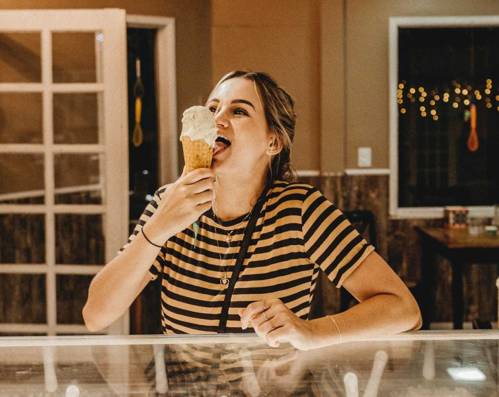 Woman Enjoying a Cone of Ice Cream | Breast Cancer Car Donations