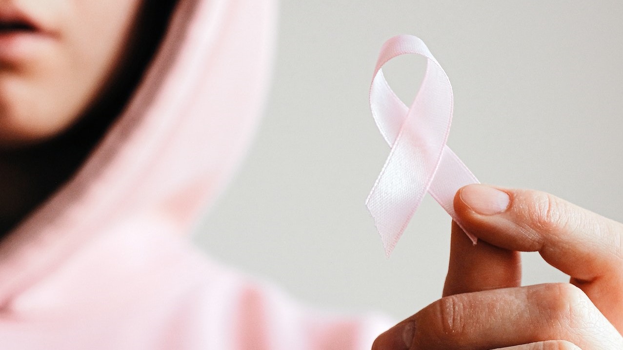 Woman Holding Pink Ribbon  | Breast Cancer Car Donations