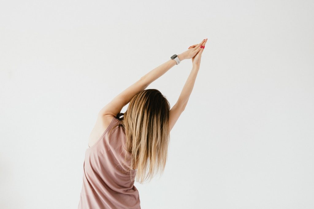 Woman In Pink Shirt Doing Stretching | Breast Cancer Car Donations