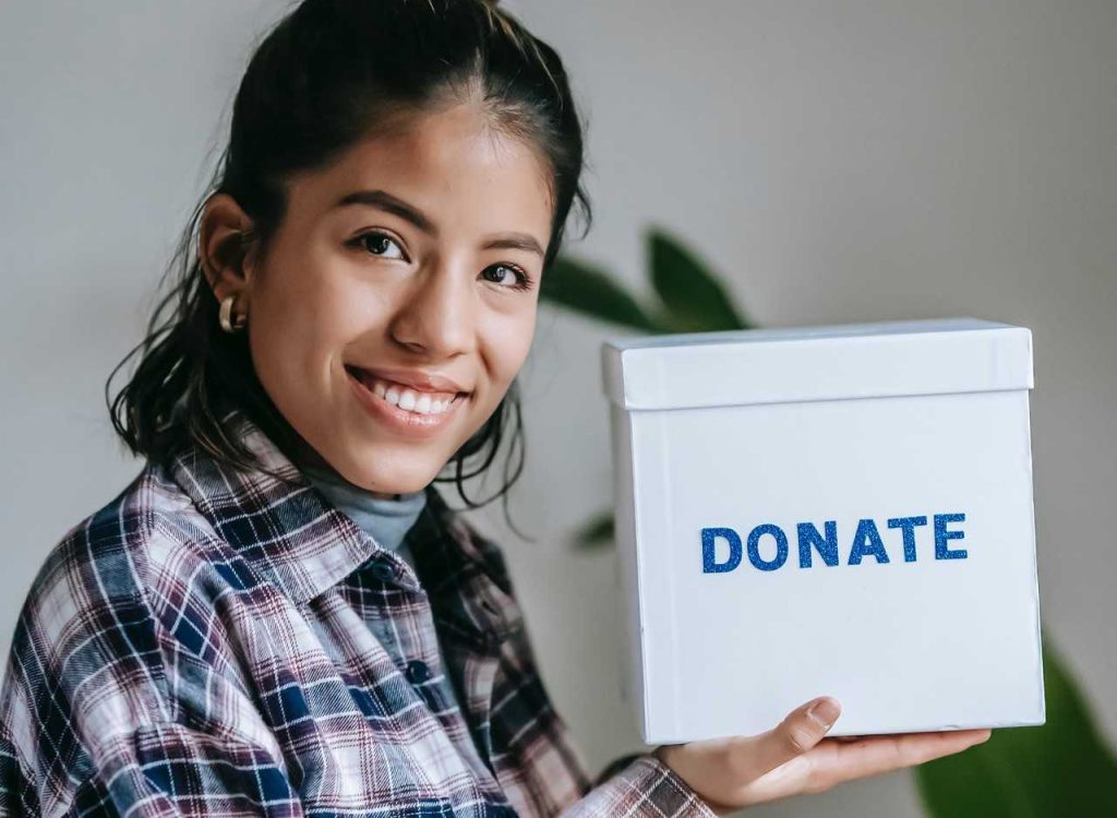 Cheerful woman with donation box | Breast Cancer Car Donations