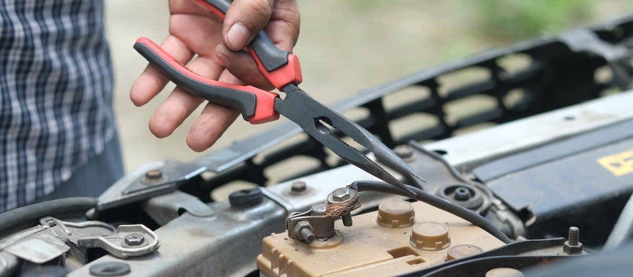 Person Holding Red and Black Hand Tool | Breast Cancer Car Donations