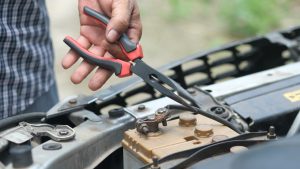 Person Holding Red and Black Hand Tool | Breast Cancer Car Donations