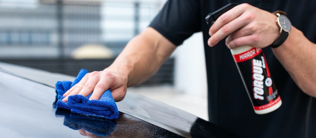 Person in Black Shirt Cleaning Black Car | Breast Cancer Car Donations