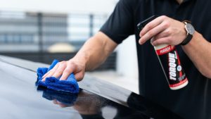 Person in Black Shirt Cleaning Black Car | Breast Cancer Car Donations