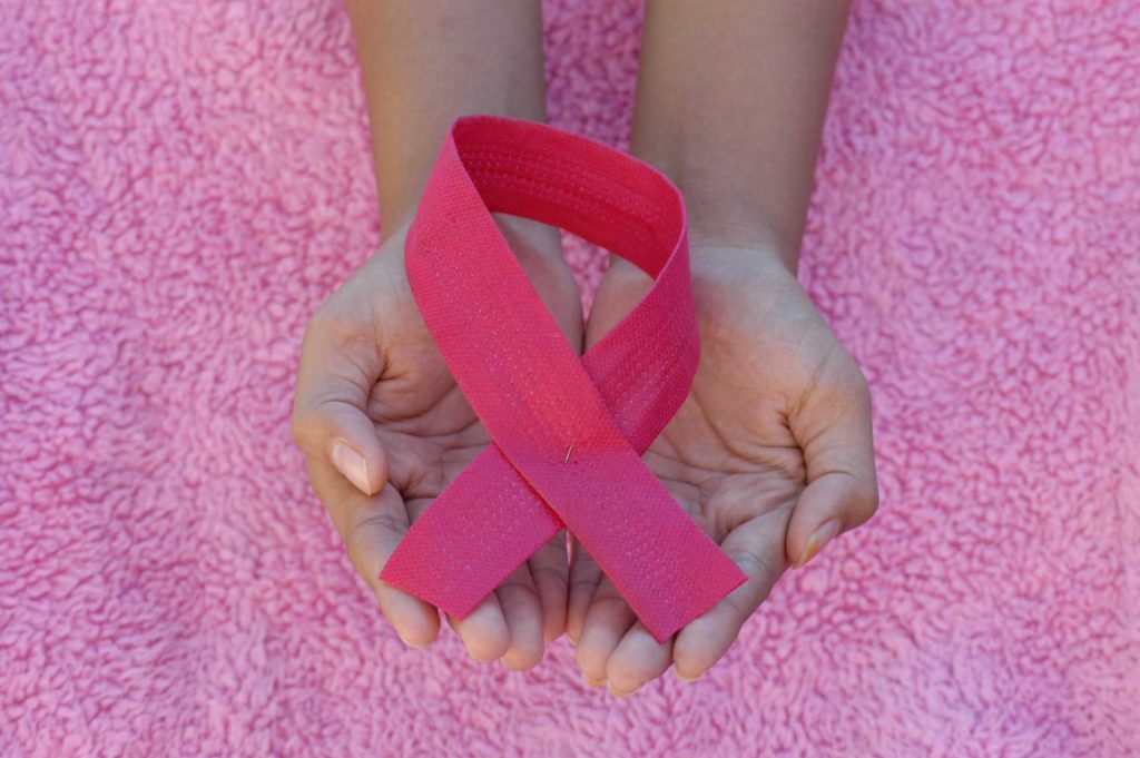 Hand Holding Pink Ribbon For Breast Cancer Awareness | Breast Cancer Car Donations