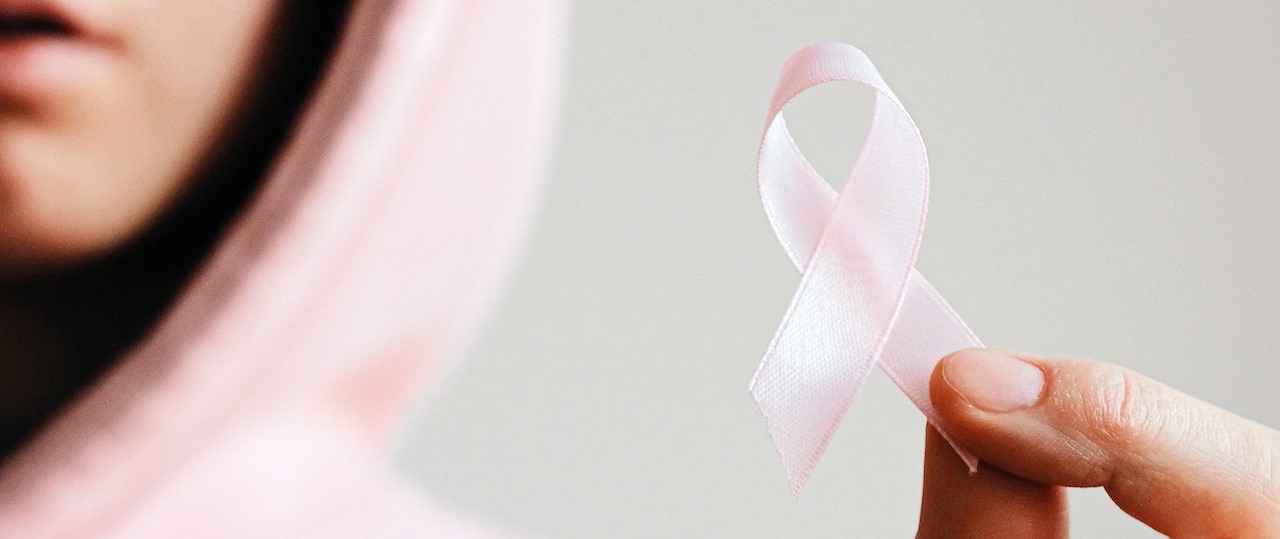 Holding Pink Ribbon (2) | Breast Cancer Car Donations