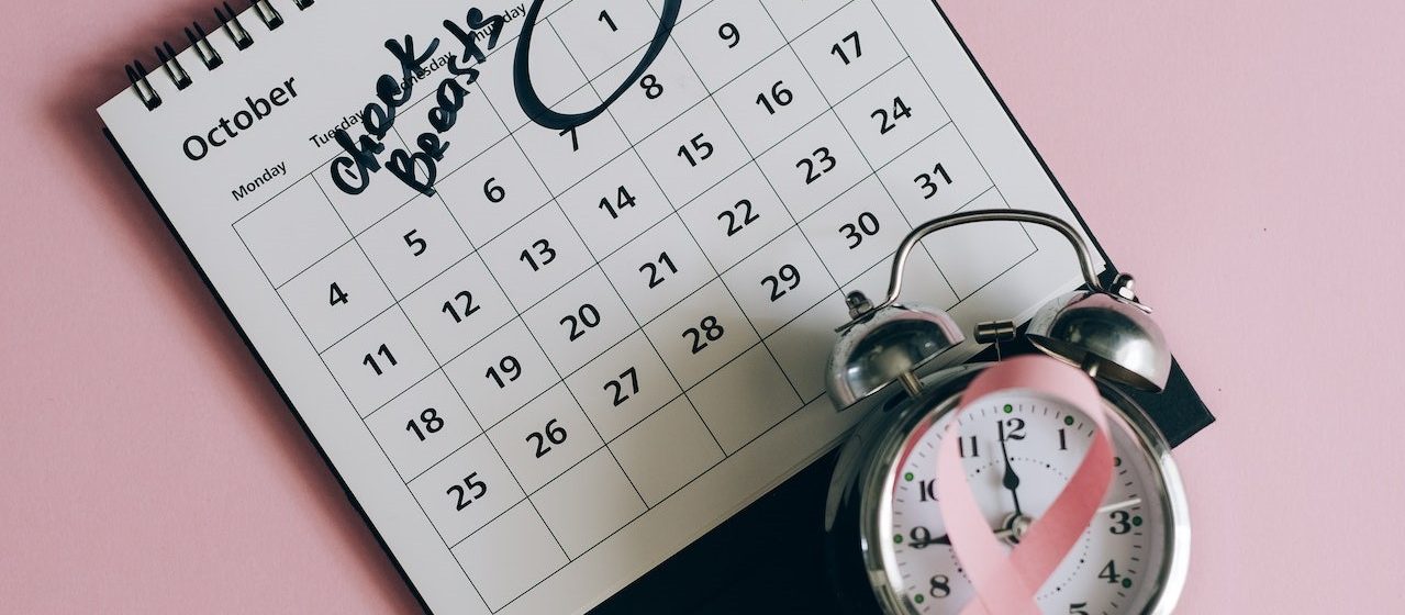 Shot of a Pink Ribbon beside a Calendar | Breast Cancer Car Donations