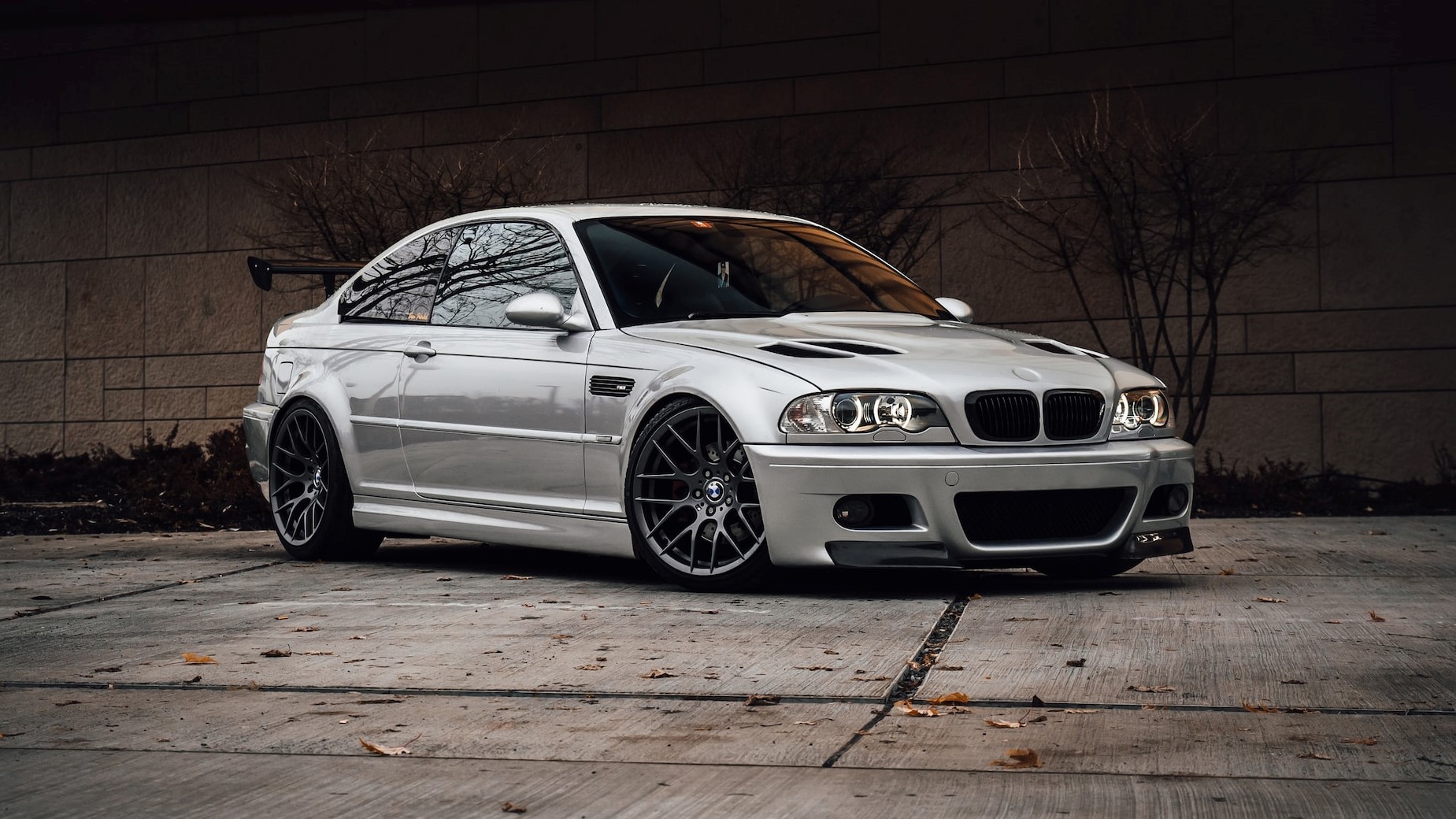 White bmw coupe beside orange wall | Breast Cancer Car Donations