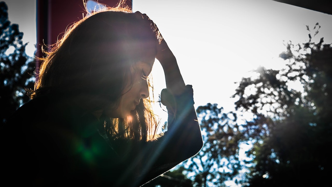 Woman Looking Holding While Holding Head | Breast Cancer Car Donations