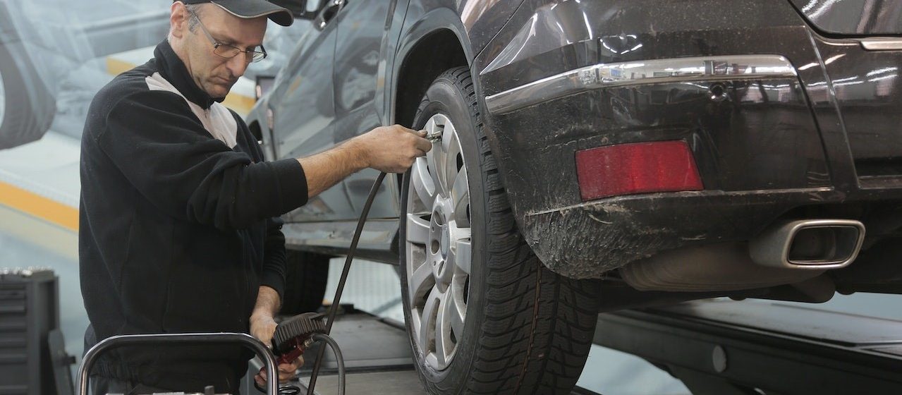 Car Mechanic Pumping Up Car with Air | Breast Cancer Car Donations