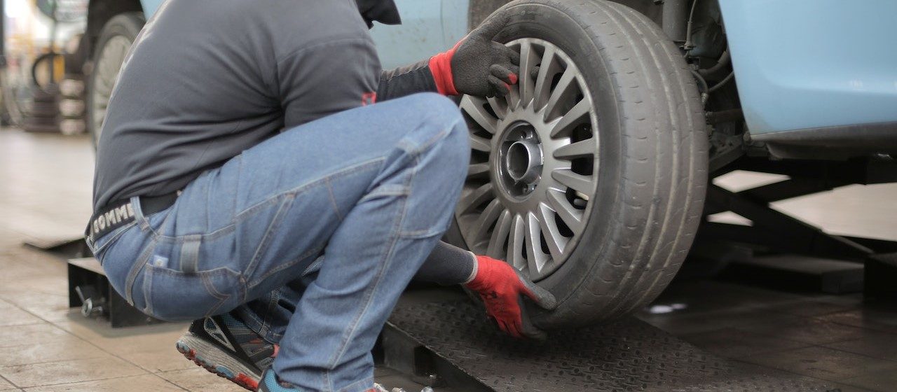 Man Changing a Car Tire (2) | Breast Cancer Car Donations