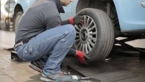 Man Changing a Car Tire (2) | Breast Cancer Car Donations
