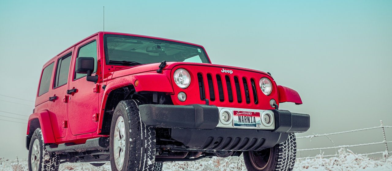 Red Jeep with Winter Tires On | Breast Cancer Car Donations