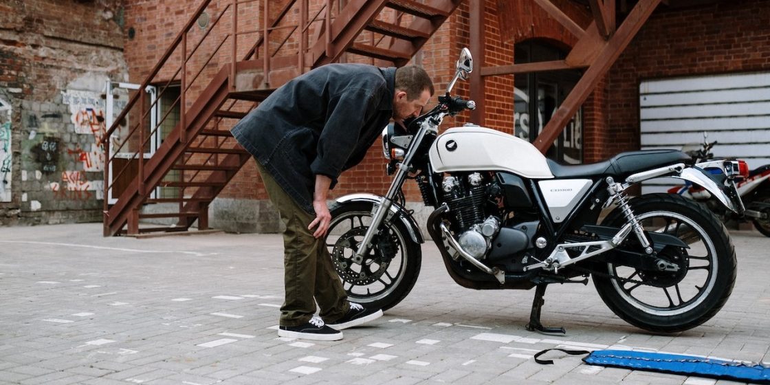 A Man Looking at a Motorcycle | Breast Cancer Car Donations