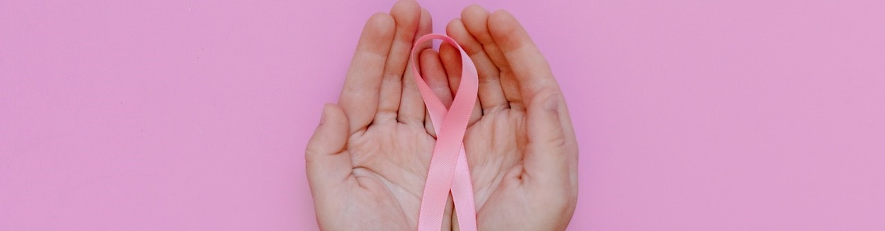 A Person Holding a Pink Ribbon | Breast Cancer Car Donations