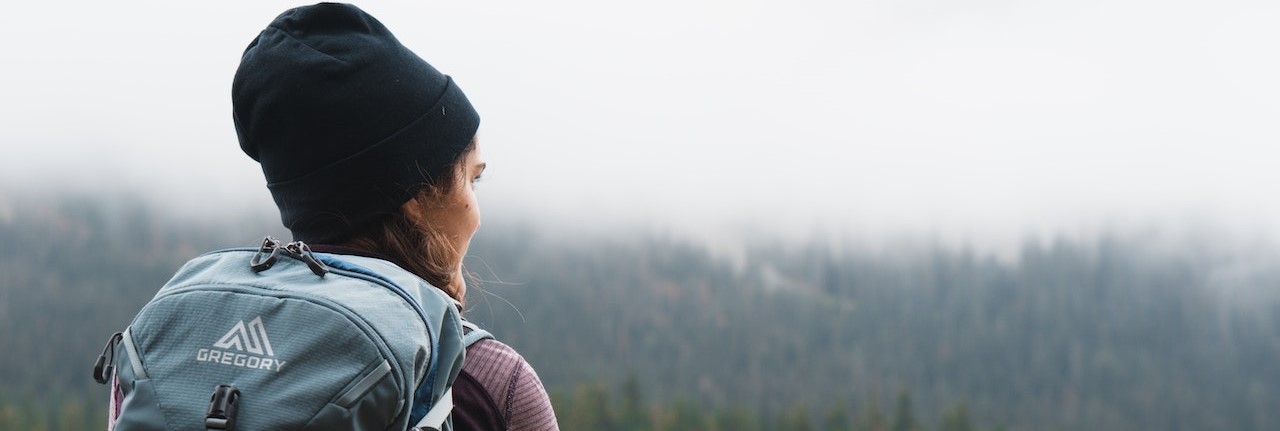 Woman Carrying Gray Backpack | Breast Cancer Car Donations