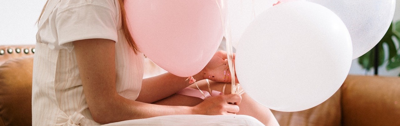 Woman Holding Pink Balloons | Breast Cancer Car Donations