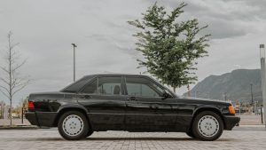 Black Classic Car Parked Beside Green Tree | Breast Cancer Car Donations