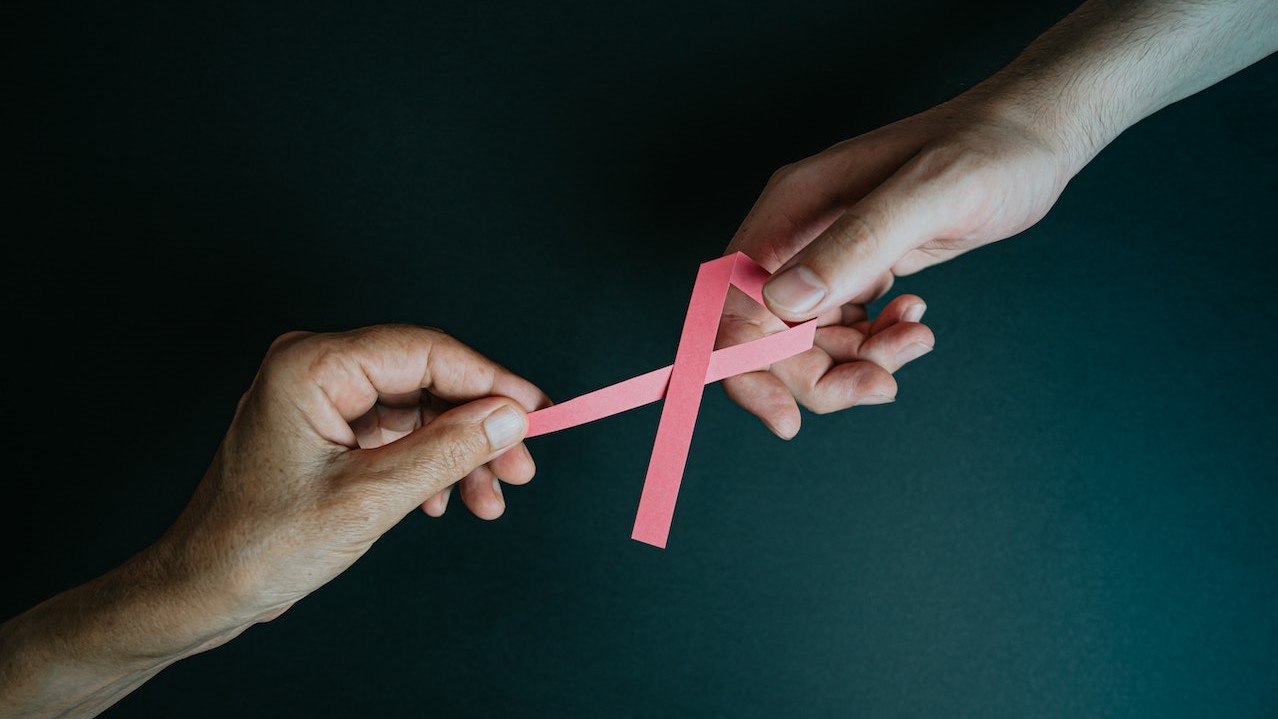 Hands Holding Breast Cancer Pink Paper Ribbon | Breast Cancer Car Donations