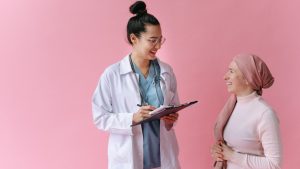 Woman in White Robe Holding Tablet Computer | Breast Cancer Car Donations