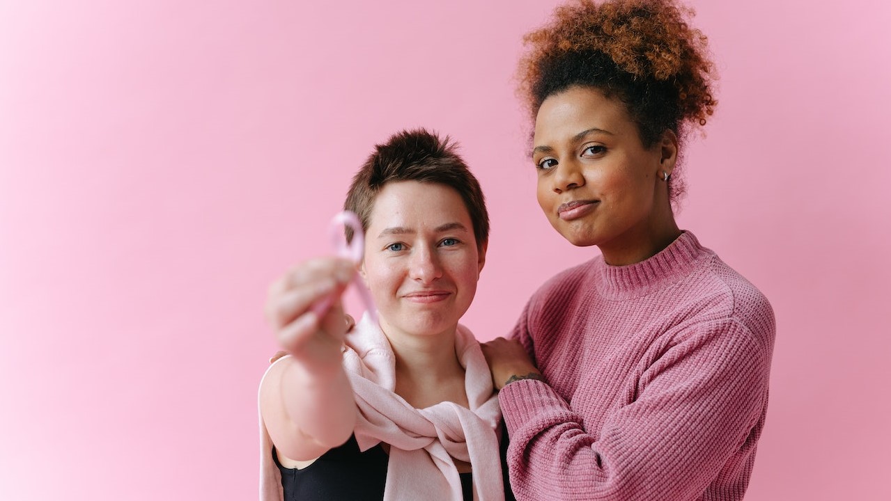 Women in Pink Outfit in a Pink Background | Breast Cancer Car Donations