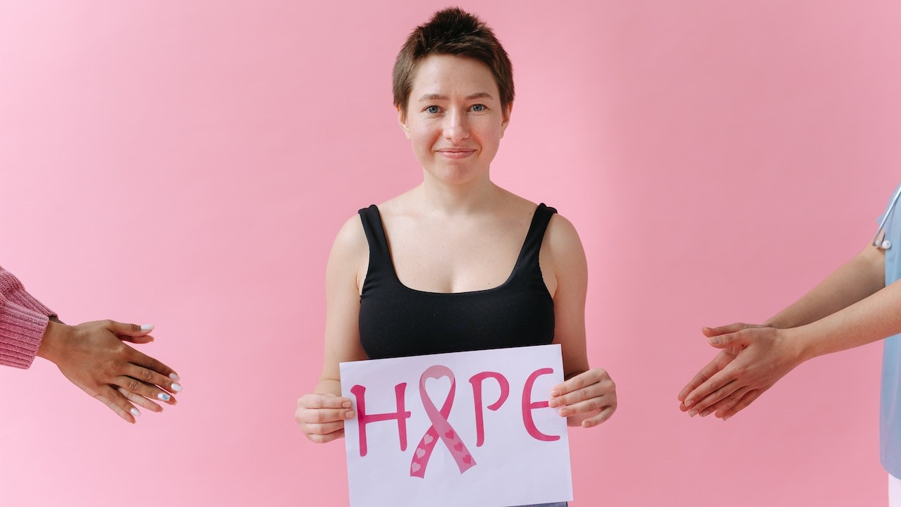 A Woman Holding Breast Cancer Awareness Placard | Breast Cancer Car Donations  