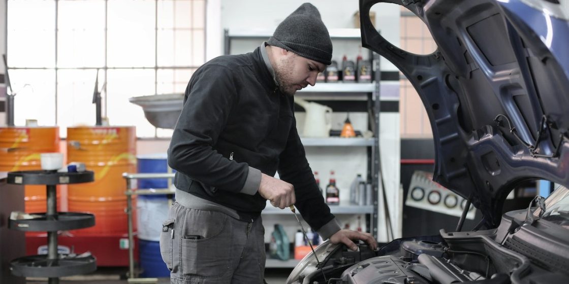 Photo of Man Inspecting Car Engine | Breast Cancer Car Donations