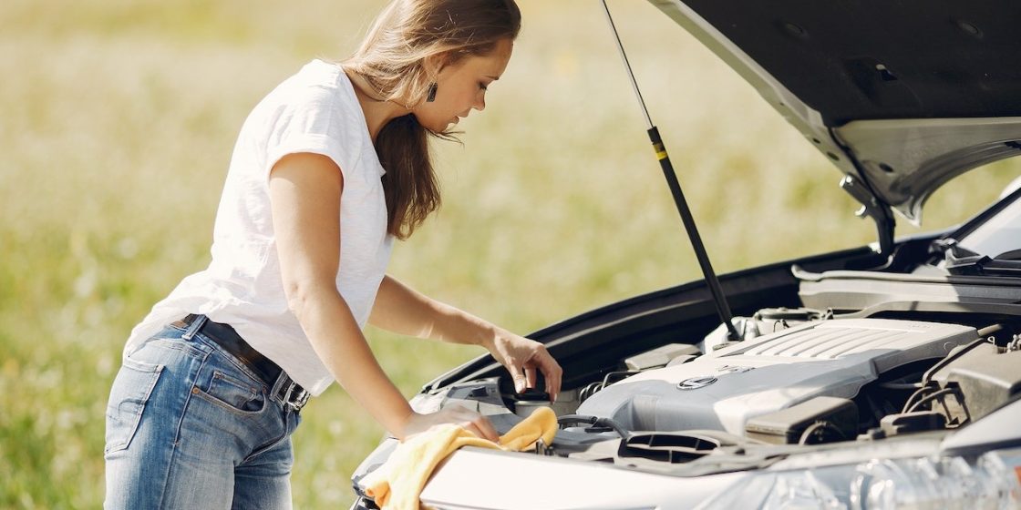 Troubled young woman near broken automobile in countryside during car accident | Breast Cancer Car Donations