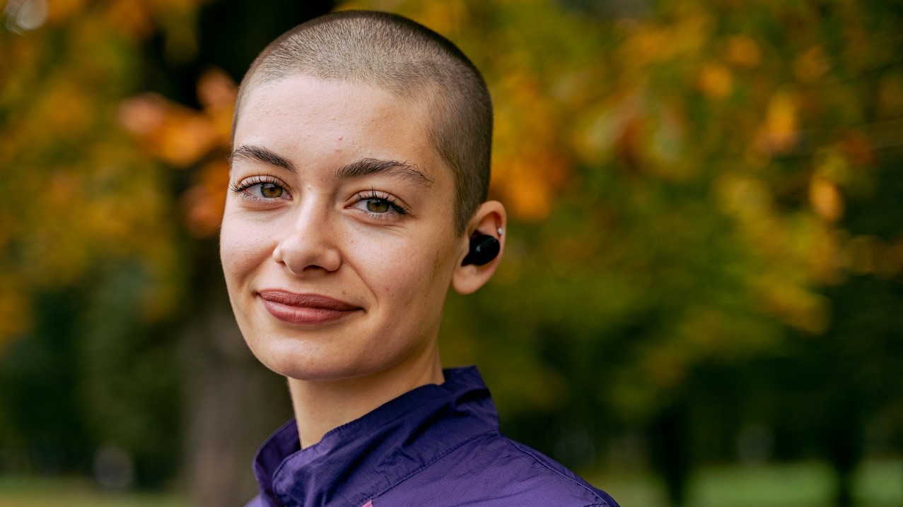 Smiling Woman in Purple Hoodie | Breast Cancer Car Donations 