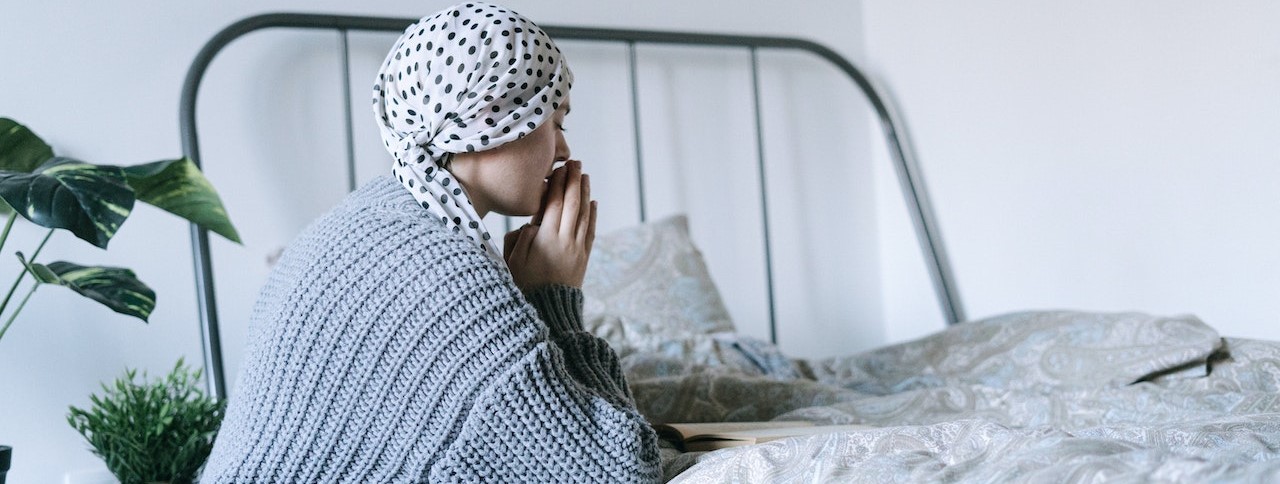 Woman in White and Black Hijab Sitting on Bed | Breast Cancer Car Donations