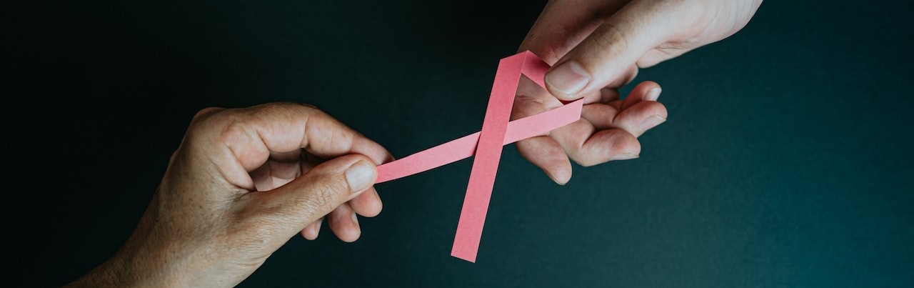 Hands Holding Breast Cancer Pink Paper Ribbon | Breast Cancer Car Donations