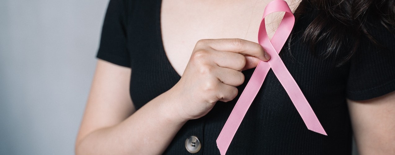 Woman Holding Pink Ribbon (2) | Breast Cancer Car Donations