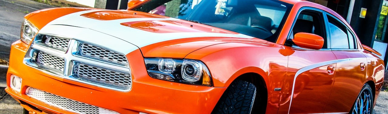 Orange Dodge Sedan on Pavement | Breast Cancer Car Donations