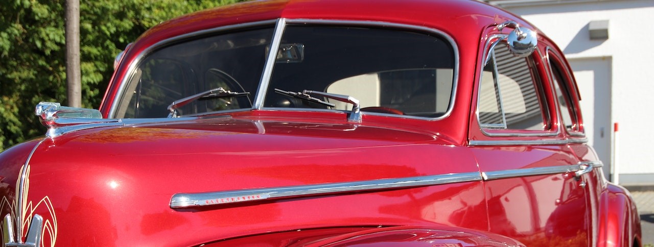 Classic Red Vehicle Parked Near Tree | Breast Cancer Car Donations