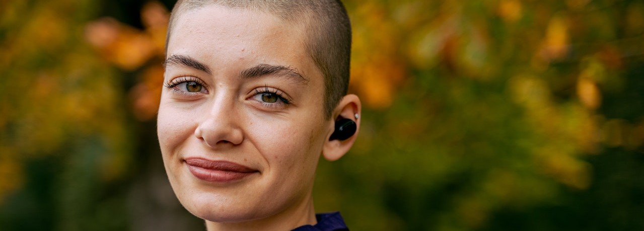 Smiling Woman in Purple Hoodie | Breast Cancer Car Donations