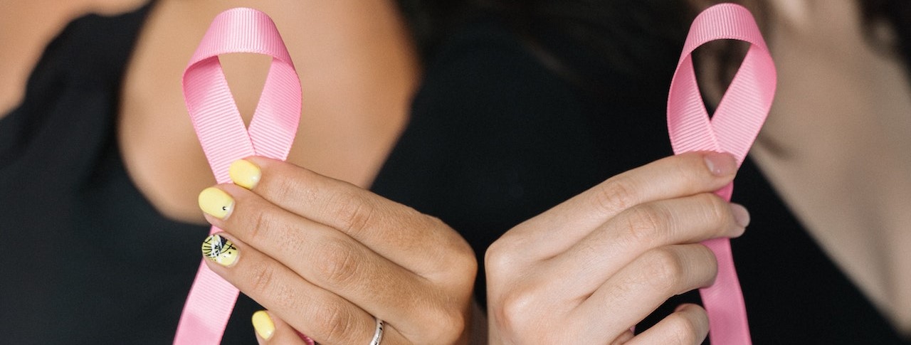 2 Women Holding Pink Ribbons | Breast Cancer Car Donations