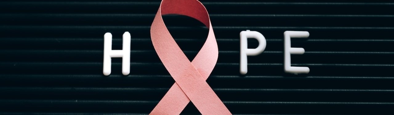 A Pink Ribbon on a Letter Board with Message | Breast Cancer Car Donations